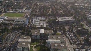 AXSF12_029 - 5K aerial stock footage tilt from freeway, revealing Apple Headquarters office buildings, Cupertino, California