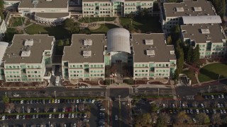 AXSF12_033 - 5K aerial stock footage fly over parking lots and reveal Apple Headquarters, tilt to bird's eye view, Cupertino, California