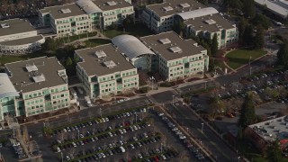 AXSF12_034 - 5K aerial stock footage of tilting from homes to reveal Apple Headquarters office buildings, Cupertino, California