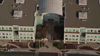 AXSF12_036 - 5K aerial stock footage approach the Apple Campus in Cupertino, California, and tilt to a bird's eye view while flying over the building