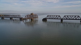 AXSF12_066 - 5K  aerial stock footage tilt from the bay to reveal and flyby the Dumbarton Rail Bridge in San Francisco Bay, California