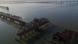 AXSF12_067 - 5K aerial stock footage of flying by a railroad bridge, Dumbarton Bridge, San Francisco Bay, California