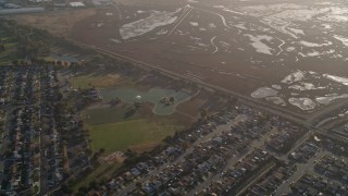 AXSF12_083 - 5K aerial stock footage reverse view of marshland, San Lorenzo Park, neighborhoods in San Lorenzo, California
