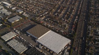 AXSF12_086 - 5K aerial stock footage fly away from suburban neighborhoods, warehouses by I-880 freeway, San Leandro, California
