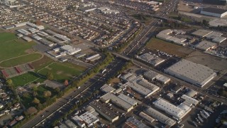 AXSF12_088 - 5K aerial stock footage reverse view of I-880, John Muir Middle School, and warehouse buildings in San Leandro, California