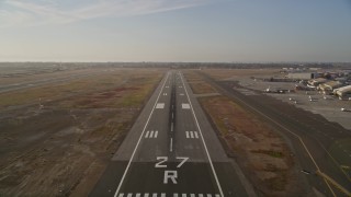 AXSF12_089 - 5K aerial stock footage tilt from golf course to reveal and approach Oakland International Airport, California