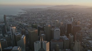 AXSF14_015 - 5K aerial stock footage tilt from city streets and fly over Financial District toward South of Market, San Francisco, California, twilight