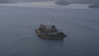 AXSF14_032 - 5K aerial stock footage of approaching Alcatraz island prison, San Francisco, California, twilight