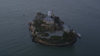 AXSF14_033 - 5K aerial stock footage approaching Alcatraz, San Francisco, California, sunset