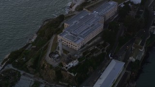 AXSF14_034 - 5K aerial stock footage flyby main buildings and lighthouse on Alcatraz island, San Francisco, California, twilight