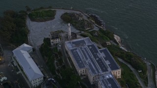 AXSF14_035 - 5K aerial stock footage orbit Alcatraz lighthouse and main building, San Francisco, California, twilight