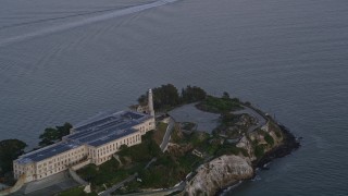 AXSF14_036 - 5K aerial stock footage of the main buildings and lighthouse on Alcatraz island, San Francisco, California, twilight