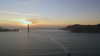 AXSF14_037 - 5K aerial stock footage of the setting sun behind the Golden Gate Bridge, San Francisco, California, sunset