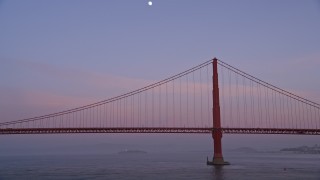 AXSF14_047 - 5K aerial stock footage fly low by the Golden Gate Bridge and pan across the span, San Francisco, California, twilight