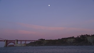 AXSF14_049 - 5K aerial stock footage south side of the Golden Gate Bridge, moon overhead, San Francisco, California, twilight