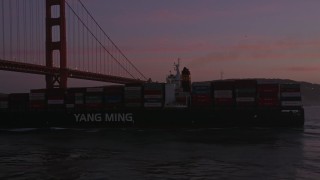 AXSF14_064 - 5K aerial stock footage orbit cargo ship and reveal Golden Gate Bridge, San Francisco, California, twilight