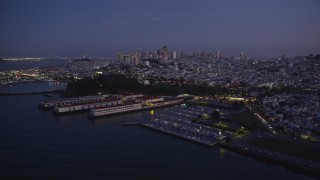 AXSF14_086 - 5K aerial stock footage flyby marina and Fort Mason, downtown skyline in the background, San Francisco, California, twilight