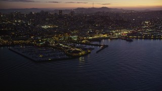 AXSF14_093 - 5K aerial stock footage of flying away from Pier 39. and Fisherman's Wharf in San Francisco, California, twilight