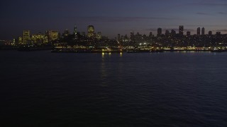 AXSF14_094 - 5K aerial stock footage low altitude approach to Pier 39 and skyline of Downtown San Francisco, California, twilight