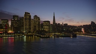 AXSF14_101 - 5K aerial stock footage of passing waterfront skyscrapers in Downtown San Francisco, California, twilight