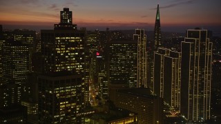 AXSF14_108 - 5K aerial stock footage pan across skyscrapers near Transamerica Pyramid in Downtown San Francisco, California, twilight