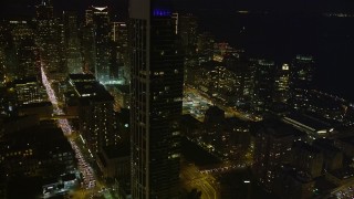 AXSF14_119 - 5K aerial stock footage heavy traffic on streets through downtown, reveal One Rincon Hill skyscraper, San Francisco, California, night