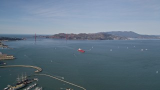 AXSF15_013 - 5K aerial stock footage of approaching an oil tanker sailing San Francisco Bay, California with a view of the Golden Gate Bridge