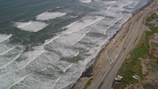 AXSF15_032 - 5K aerial stock footage video of a reverse view of ocean waves and Great Highway, Lakeshore District, San Francisco, California