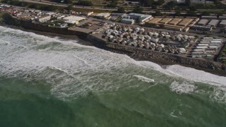 AXSF15_038 - 5K aerial stock footage of flying by oceanfront homes as waves roll in, Pacifica, California