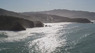 AXSF15_039 - 5K aerial stock footage of tilting from the ocean revealing coastal homes, Pacifica, California