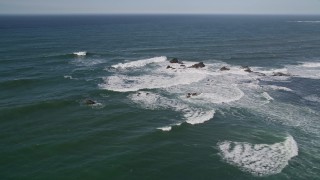 AXSF15_053 - 5K aerial stock footage of flying by waves crashing into rock formations, Half Moon Bay, California
