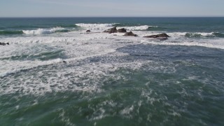 AXSF15_055 - 5K aerial stock footage tilt to reveal rock formations and fly out over ocean, Half Moon Bay, California