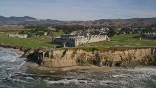 AXSF15_056 - 5K aerial stock footage of flying by an oceanfront hotel on coastal cliffs, Half Moon Bay, California