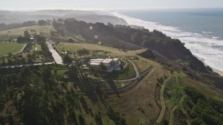 AXSF15_063 - 5K aerial stock footage fly over hills to reveal an isolated mansion on a hilltop near the coast, San Gregorio, California