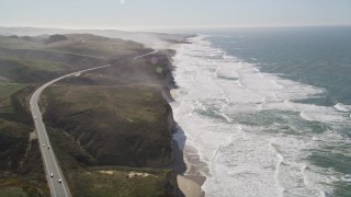 AXSF15_069 - 5K aerial stock footage tilt from Highway 1 and fly over coastal cliffs, Pescadero, California