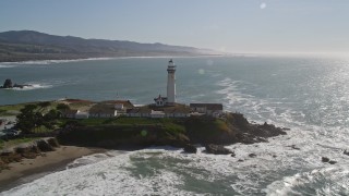AXSF15_071 - 5K aerial stock footage of tilting from the ocean to reveal and flyby Pigeon Point Light Station, Pescadero, California