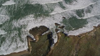AXSF15_074 - 5K aerial stock footage of a reverse view of ocean waves, revealing the coast, Pescadero, California