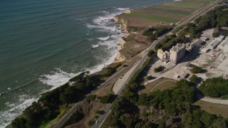 AXSF15_084 - 5K aerial stock footage of flying away from coastal Highway 1 and a cement plant, Davenport, California