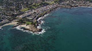 AXSF16_011 - 5K aerial stock footage tilt from ocean kelp to reveal coastal residential neighborhoods, Monterey, California