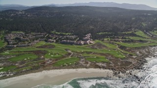 AXSF16_018 - 5K aerial stock footage of flying by a coastal resort and golf course, Pebble Beach, California