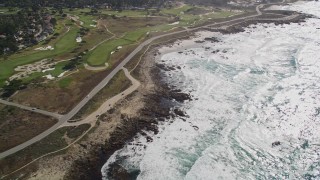 AXSF16_021 - 5K aerial stock footage of a coastal road and golf course in Pebble Beach, California