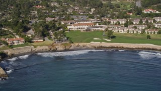 AXSF16_029 - 5K aerial stock footage tilt from the ocean to reveal Pebble Beach Golf Links and Pebble Beach Resorts, California