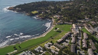 AXSF16_031 - 5K aerial stock footage of Pebble Beach Resorts hotel, tennis courts, and Pebble Beach Golf Links by Carmel Bay, Pebble Beach, California