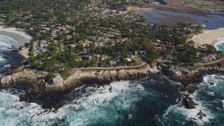AXSF16_038 - 5K aerial stock footage tilt from the ocean to reveal a coastal residential neighborhood in Carmel, California