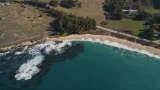 AXSF16_040 - 5K aerial stock footage pan from beach to reveal Carmel Monastery, Carmel, California