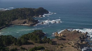 AXSF16_044 - 5K aerial stock footage of tilting from a coastal highway to reveal Whalers Cove, Carmel, California