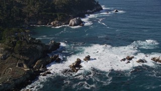AXSF16_045 - 5K aerial stock footage of tilting from the coves along the coast to reveal coastal cliffs, Carmel, California