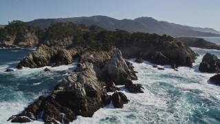 AXSF16_047 - 5K aerial stock footage tilt to reveal waves crashing into coastal rock formations, Carmel, California
