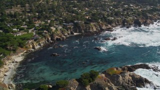 AXSF16_051 - 5K aerial stock footage of panning to oceanfront homes and a cove on the coast, Carmel, California