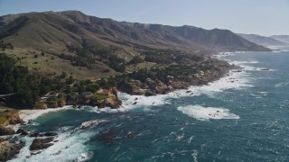 AXSF16_052 - 5K aerial stock footage flyby waves crashing below coastal homes and tilt up to the coastline, Carmel, California